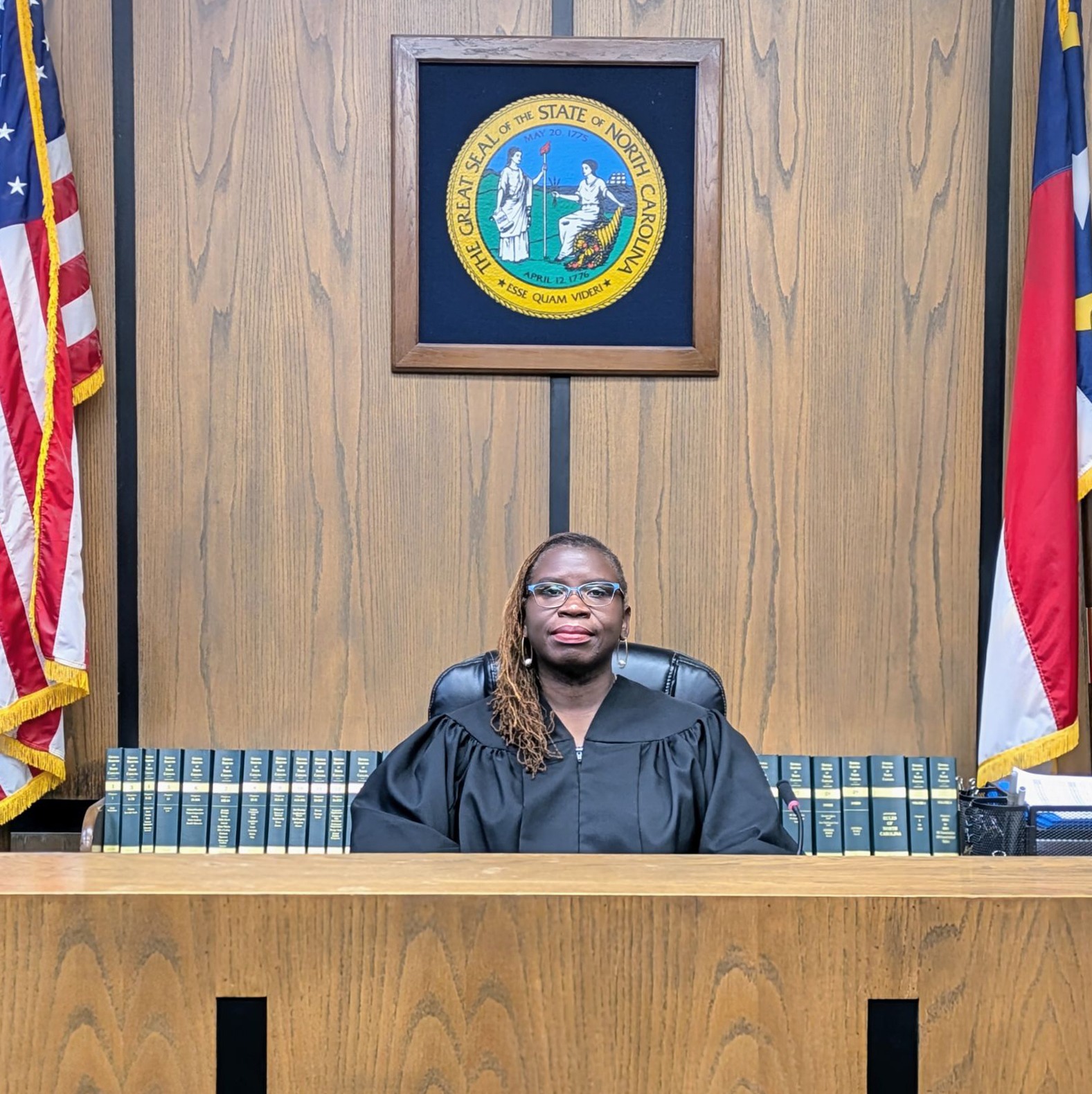 Judge Angela Woods with flags and seal